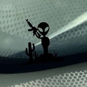 Tiny alien holding AR windshield easter egg decal, easter egg decals, 4x4 easter egg decal, rifle decal, small decal, small sticker,