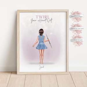 May include: A framed print featuring a cartoon illustration of a person in a blue dress twirling a baton. The text "TWIRL Your Heart Out" is above the figure, with the name "Jewel" below. The print is in a light wood frame.