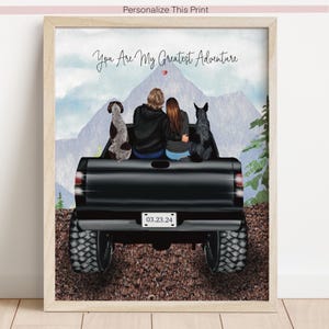 May include: Framed print showing a couple and two dogs in a black truck, with the text "You Are My Greatest Adventure." The background features mountains and trees. The date "03.23.24" is on the number plate.