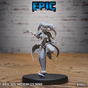 May include: A gray miniature of a jester figure holding a small blade, standing on a black base. The jester has a detailed costume with a cape and a hat with bells. The base size is medium, 25.5mm. The Epic Miniatures logo is at the top.