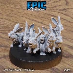 May include: A group of 9 grey, unpainted, miniature rabbit figurines with long ears, standing on a black circular base. The base is labeled "BASE SIZE: SMALL (19.13MM)" and "#5067".