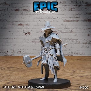 May include: A gray, detailed miniature figure of a person wearing a large hat, armor, and a long cloak. The figure is holding a large hammer and is standing on a round base. The figure is labeled "#4600" and "BASE SIZE: MEDIUM (25.5MM)".