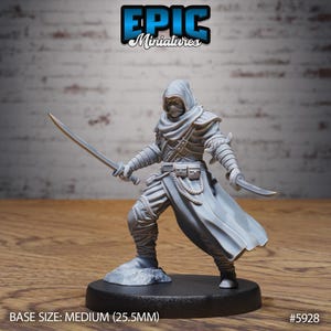 May include: A gray miniature figure of a hooded warrior holding two curved swords. The figure is in a dynamic pose, standing on a small, round base. The text "EPIC Miniatures" is at the top. The base size is medium (25.5mm).