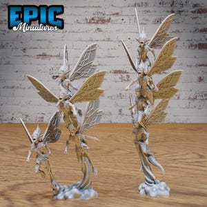 May include: A set of five miniature fairy figurines with wings, each perched on a cloud-like base. The fairies are stacked on top of each other, creating a tower-like structure. The fairies are made of a light gray material and have a detailed, realistic appearance.
