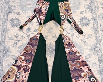 May include: A two-piece outfit featuring a dark green high-waisted bottom and matching flared leg pieces. The flared sections have a paisley pattern in shades of brown, pink, and cream. Gold-colored rings connect the top and bottom pieces.