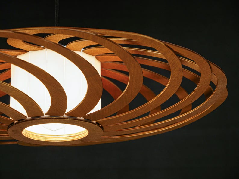 Stylish wooden ceiling lamp with warm, diffused lighting. Handcrafted from sustainable plywood for modern and Scandinavian interiors. A unique pendant light fixture that adds depth and character to any room.
