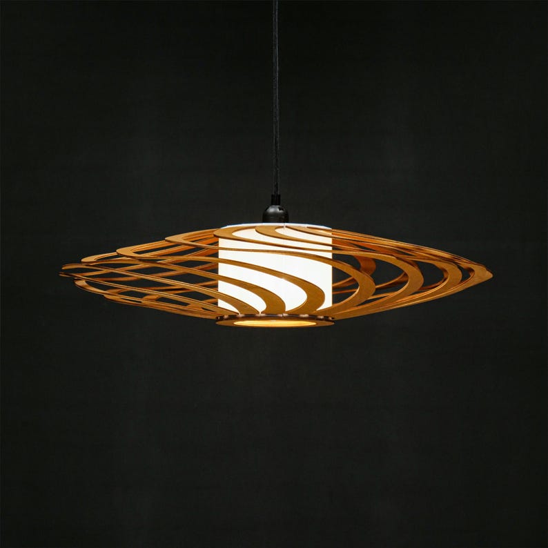 Contemporary wooden ceiling light featuring geometric laser-cut layers. A statement piece for Scandinavian, loft, or boho-style interiors. Handmade from sustainable plywood for a warm and cozy atmosphere.