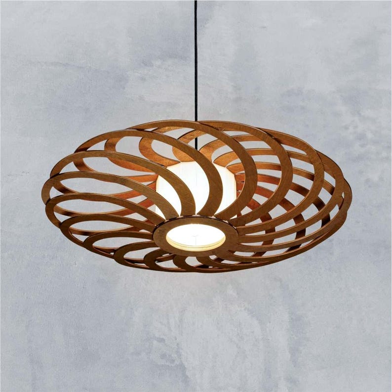 Modern brown plywood pendant light with an intricate spiral open-frame design, handcrafted wooden ceiling lampshade casting warm ambient glow against a minimalist concrete wall.