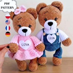 May include: Two crocheted teddy bears made of brown yarn with white muzzles. The left bear wears a pink dress with a white heart patch labeled LENA and a pink bow. The right bear wears blue overalls with a white heart patch labeled LEON.
