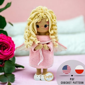 May include: A handmade crochet angel doll with blonde curly hair, wearing a pink dress and white shoes. The doll has small wings and a gold halo. The image includes the text "PDF Crochet Pattern".