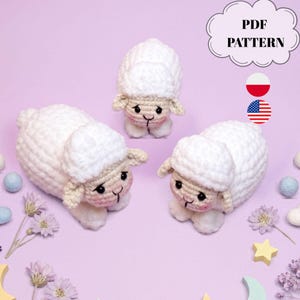 May include: Three white crocheted sheep toys with textured wool, black eyes, and pink cheeks. The image includes text that reads PDF PATTERN, along with Polish and American flag icons. The sheep are arranged on a light purple background.