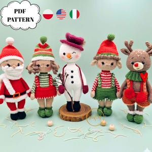 May include: Five handmade crochet Christmas figures: Santa Claus, a girl, a snowman, an elf, and a reindeer. Each figure is dressed in festive attire, with red, green, and white colours. The figures are displayed on a light green background.