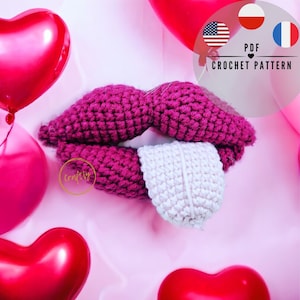 May include: Crochet pattern for a pink and white crocheted lips with a tongue. The pattern is available in PDF format and includes instructions in English, French, and Polish. The image also includes the text "Crafty".