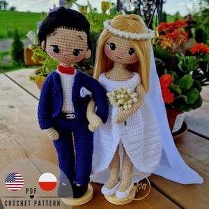 May include: Crochet pattern for a bride and groom doll couple. The bride is wearing a white dress with a veil and holding a bouquet of flowers. The groom is wearing a blue suit with a white shirt and a red bow tie. The dolls are standing on wooden bases.