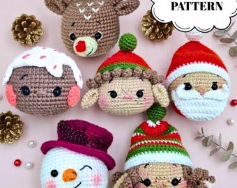 May include: A collection of six crocheted Christmas ornaments featuring a reindeer, a pudding, an elf, Santa Claus, a winking snowman with a purple hat, and a character in a striped hat. The image includes the text PDF PATTERN in a speech bubble.