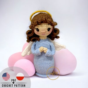 May include: Crochet pattern for a blue angel doll with brown hair and a halo. The doll is holding its hands together in prayer. The pattern is available in English and Polish.
