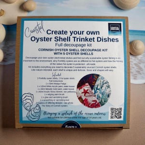 May include: A decoupage kit for making oyster shell trinket dishes. The box includes oyster shells, paints, varnish, brushes, and napkins. The text on the box says "Create your own Oyster Shell Trinket Dishes".