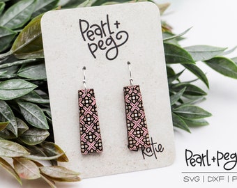 May include: A pair of pink and black geometric patterned dangle earrings with silver hooks. The earrings are displayed on a card with the text "Pearl + Peg" and "SVG | DXF | PDF".