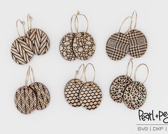 May include: Six pairs of wooden earrings with different geometric patterns. The earrings are oval shaped and have gold hoops. The patterns include herringbone, polka dots, houndstooth, a honeycomb pattern, and a leopard print.