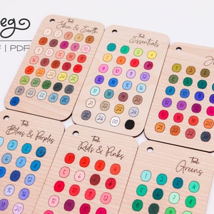 May include: A set of ten colour charts for crafting, each with a different colour theme. The charts are made of wood and have a hole at the top for hanging. The themes include: Skin & Earth, Essentials, Jewel, Blues & Purples, Reds & Pinks, and Greens.