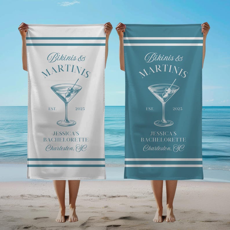 May include: Two white beach towels with blue stripes. The towels have the text "Bikinis & Martinis" with a martini glass graphic and the text "Jessica's Bachelorette Charleston, SC".
