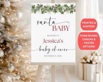 May include: A white sign on an easel with the text "Santa Baby" and "Jessica's baby shower." The sign is decorated with a green and red floral border. The sign also has the text "Printed & Shipped!" and "Foam Board, Canvas & Poster Options!"
