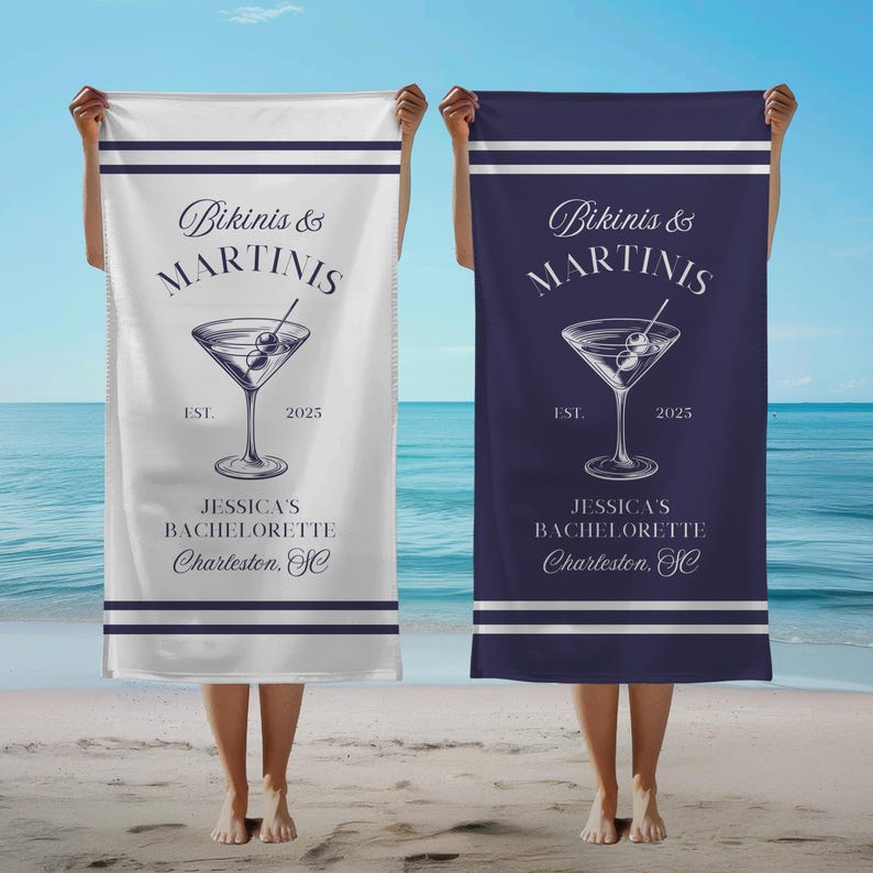 May include: Two white beach towels with blue stripes. The towels feature a martini glass with olives and the text "Bikinis & Martinis" with the year 2025. The text "Jessica's Bachelorette Charleston, SC" is also on the towels.