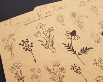 May include: A sheet of brown paper with black line drawings of various flowers and plants. The paper has the text "Time & Tale timeandtale.etsy.com" printed on it.
