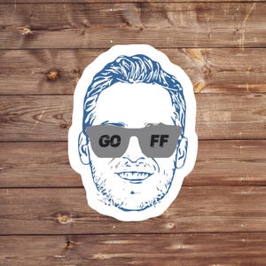 May include: A blue and white line drawing of a person wearing sunglasses with the words "GO FF" printed on the lenses.