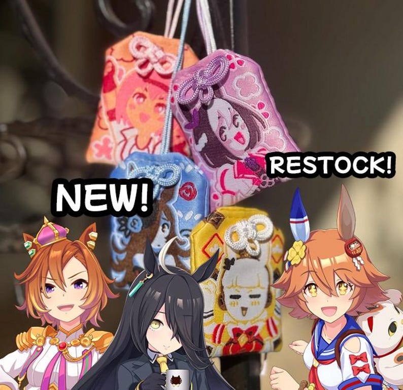 May include: Four rectangular fabric omamori charms featuring embroidered anime-style character illustrations in orange, purple, blue, and yellow. The charms have decorative knotted cords at the top. Text overlays read NEW! and RESTOCK!