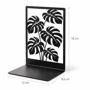 Peut inclure: Soutien-livres en métal noir avec un motif de feuilles de monstera. Le serre-livres mesure 18 cm de haut, 12 cm de large et 8,5 cm de profondeur. Le motif est une silhouette noire et blanche des feuilles de la plante. Un objet décoratif pour la maison ou le bureau.
