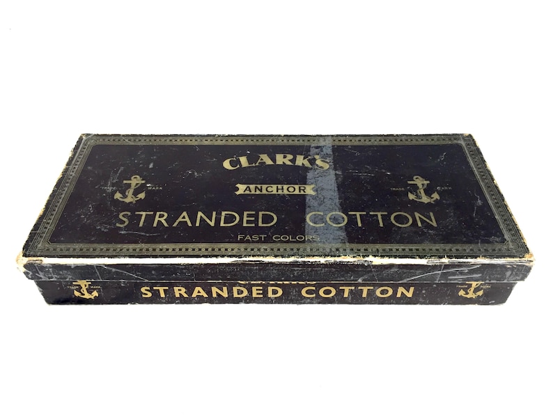 May include: A black box with gold lettering that reads "Clark's Anchor Stranded Cotton Fast Colors" and a smaller label on the bottom that reads "Stranded Cotton".