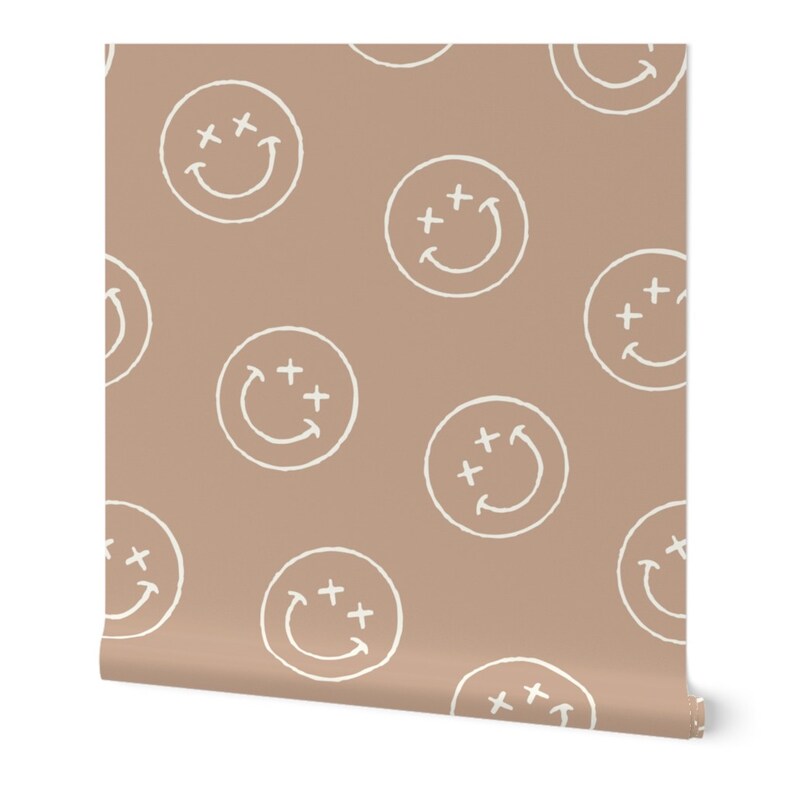 May include: A seamless pattern wallpaper featuring white smiley faces with plus signs on a light brown background.