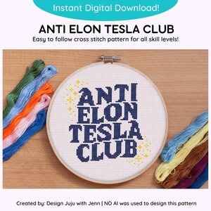 May include: A cross stitch pattern in a hoop with the text "ANTI ELON TESLA CLUB" in blue letters with yellow stars. The pattern is surrounded by colorful embroidery floss.