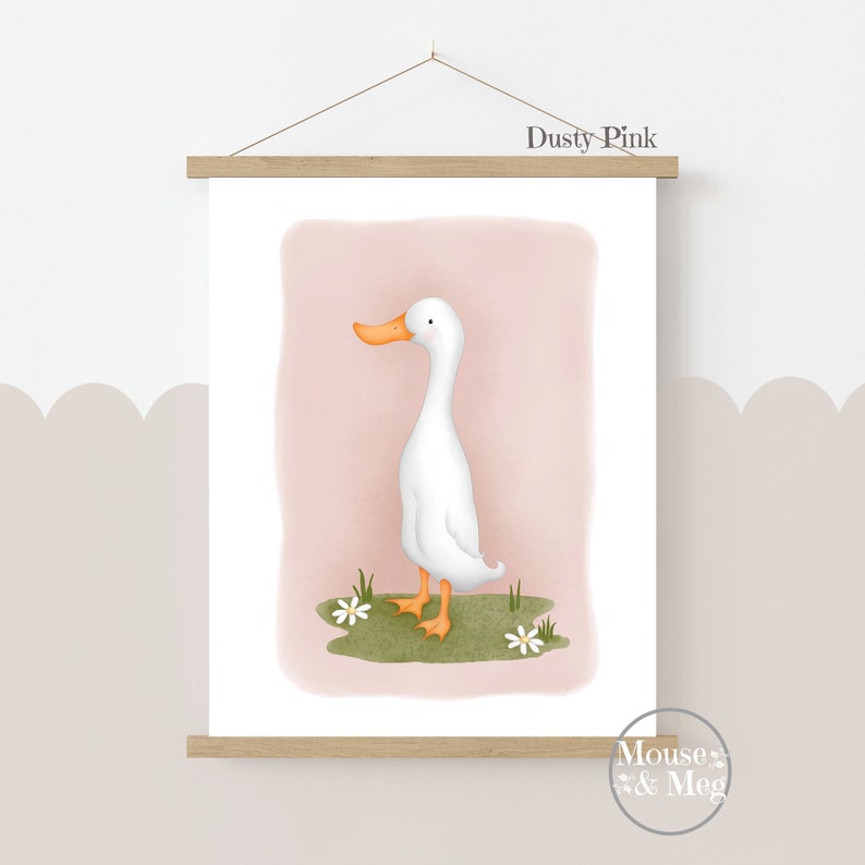 May include: A printable art print featuring a white duck with an orange beak standing on a green patch of grass with white flowers. The background is a dusty pink color. The print is titled "Dusty Pink" and is by Mouse & Meg.
