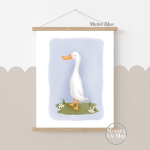 May include: A digital illustration of a white duck with an orange beak standing on a patch of green grass with white flowers. The background is a muted blue color. The text "Muted Blue" is at the top of the image.