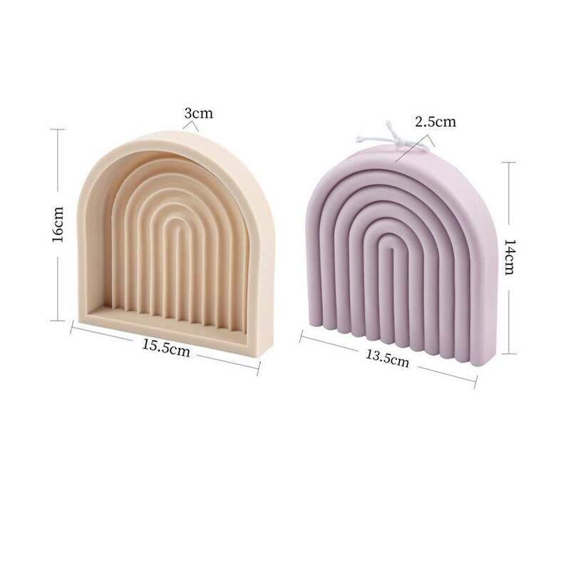 May include: Two silicone moulds for making rainbow-shaped candles. The mould on the left is beige and measures 16 cm tall, 15.5 cm wide, and 3 cm deep. The mould on the right is purple and measures 14 cm tall, 13.5 cm wide, and 2.5 cm deep.
