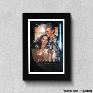 May include: Framed Star Wars Episode II: Attack of the Clones movie poster. The poster features Anakin Skywalker, Padmé Amidala, Obi-Wan Kenobi, and a clone trooper. The poster is in a black frame with a white border. The text "Frame not included" is at the bottom.