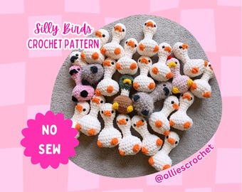 May include: A collection of crocheted bird figures in white with orange accents, arranged on a gray surface. The image includes text that reads "Silly Birds CROCHET PATTERN" and "NO SEW". The background is pink.
