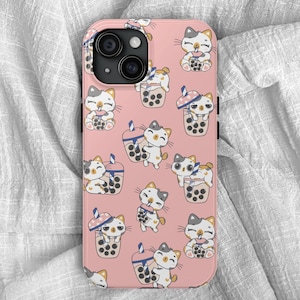 May include: A pink phone case with a pattern of white cats drinking boba tea. The case has a camera lens cutout and a white border.