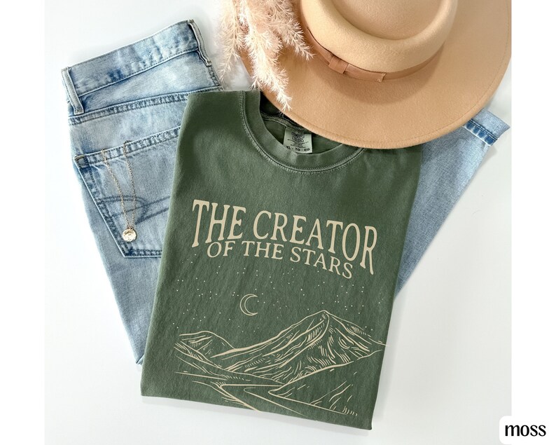 May include: A green t-shirt with the text "The Creator of the Stars" and a mountain range with a crescent moon graphic.