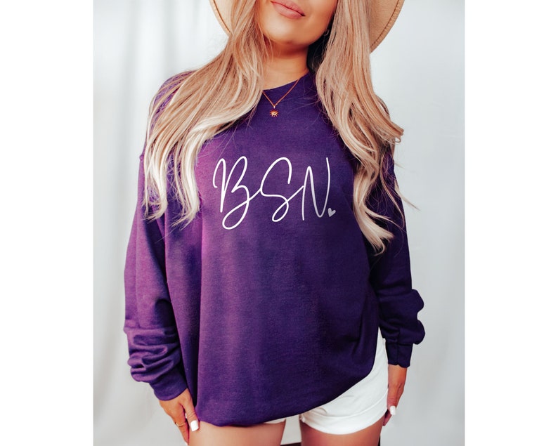 May include: A purple sweatshirt with the text "BSN" in white script lettering and a small white heart.