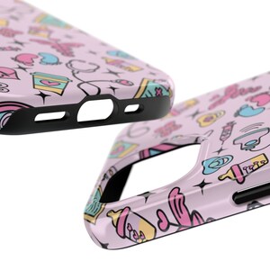 May include: A pink phone case with a colorful pattern of baby-related icons, including a bottle, a pacifier, and a rattle. The case has a black bumper and cutouts for the camera and buttons.