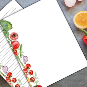 May include: Printable lined paper with a watercolor border of tomatoes, onions, and green leaves. The paper is white with gray lines.