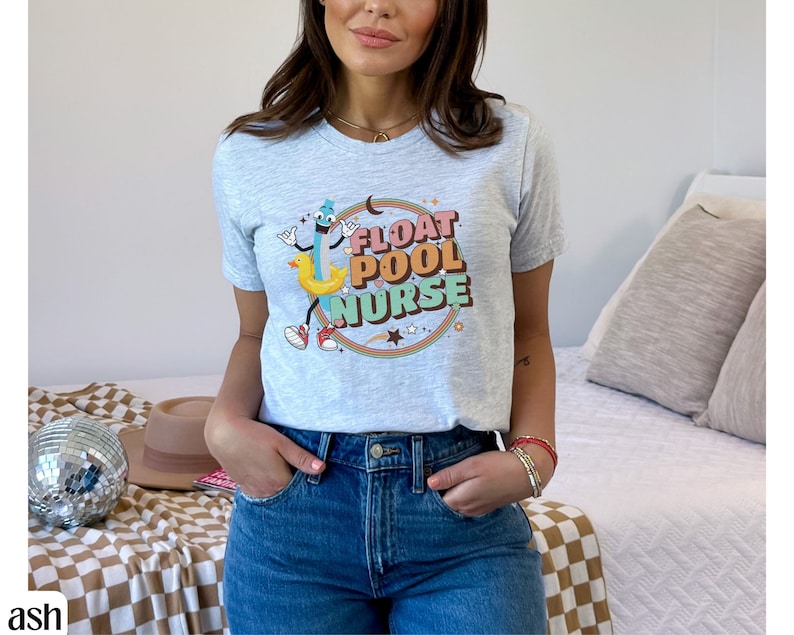 May include: A grey t-shirt with a cartoon illustration of a pool float and the text "Float Pool Nurse" in a retro font.