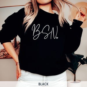 May include: Black sweatshirt with white cursive text that says "BSN".