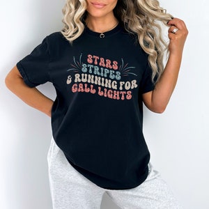 May include: A black t-shirt with a white graphic that says "Stars & Stripes & Running for Call Lights".