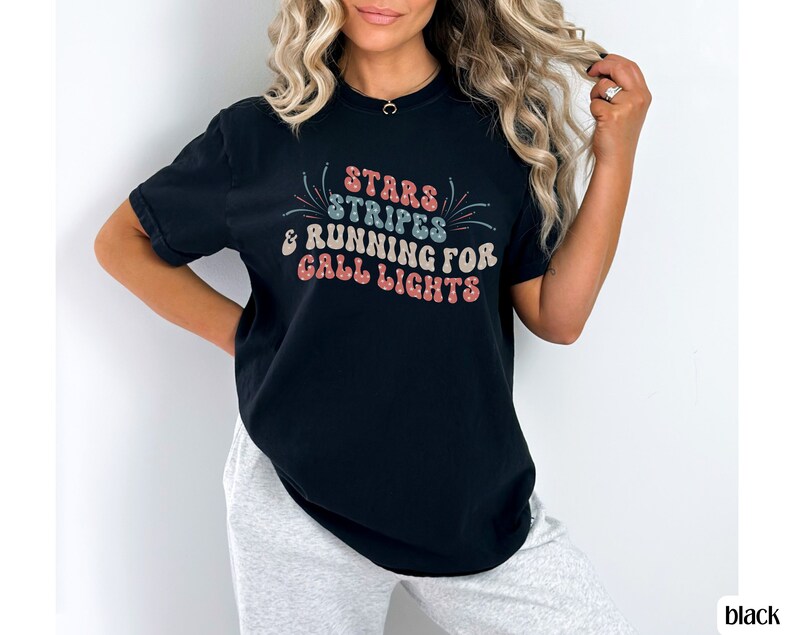 May include: A black t-shirt with a white graphic that says "Stars & Stripes & Running for Call Lights".
