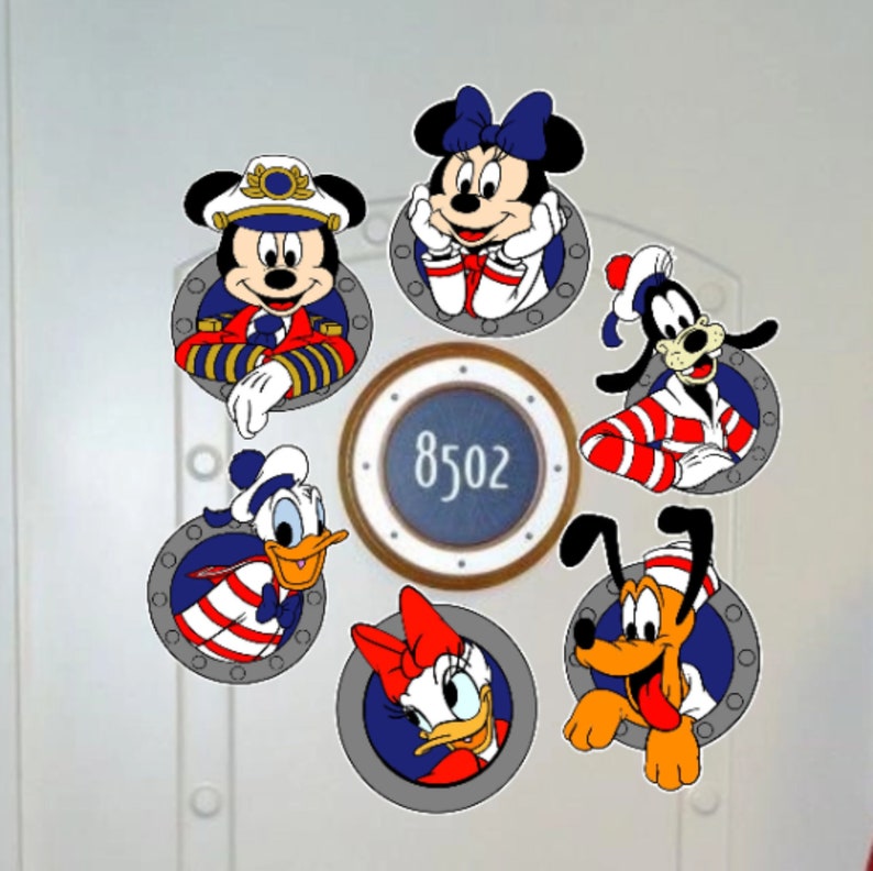 May include: A white door with six round porthole stickers featuring various Disney characters in nautical outfits. The portholes have a blue background with a white border. The centre porthole has a blue background with a white border and the number 8502.