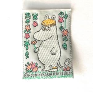 May include: A handmade, wooden cutting board with a natural finish. The board features a live edge on one side and a smooth, rectangular shape. It measures approximately 18 inches long and 12 inches wide.